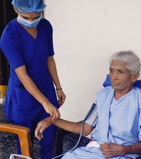 Physiotherapist guiding senior through gait training for stroke rehabilitation at the best rehabilitation center